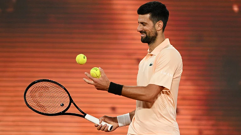 Novak Djokovic playing against Giovanni Mpetshi Perricard during a tough tennis match