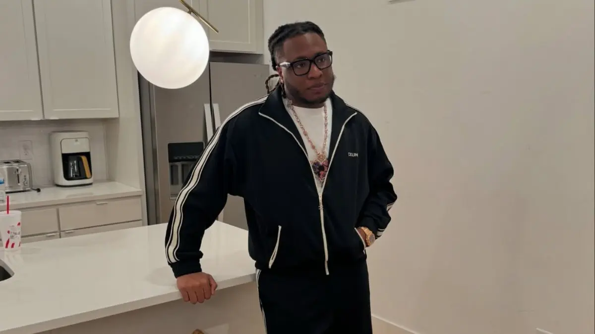 Tay Keith working in a music studio, producing hip-hop beats and recording tracks