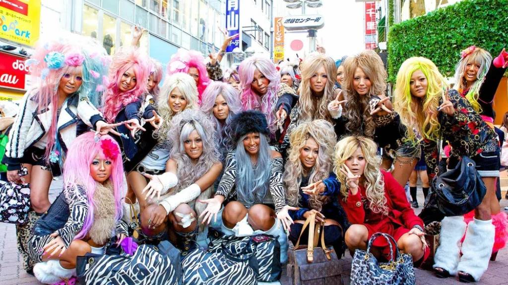 Models wearing Gyaru fashion with bold makeup, styled hair, platform boots, and trendy Japanese streetwear